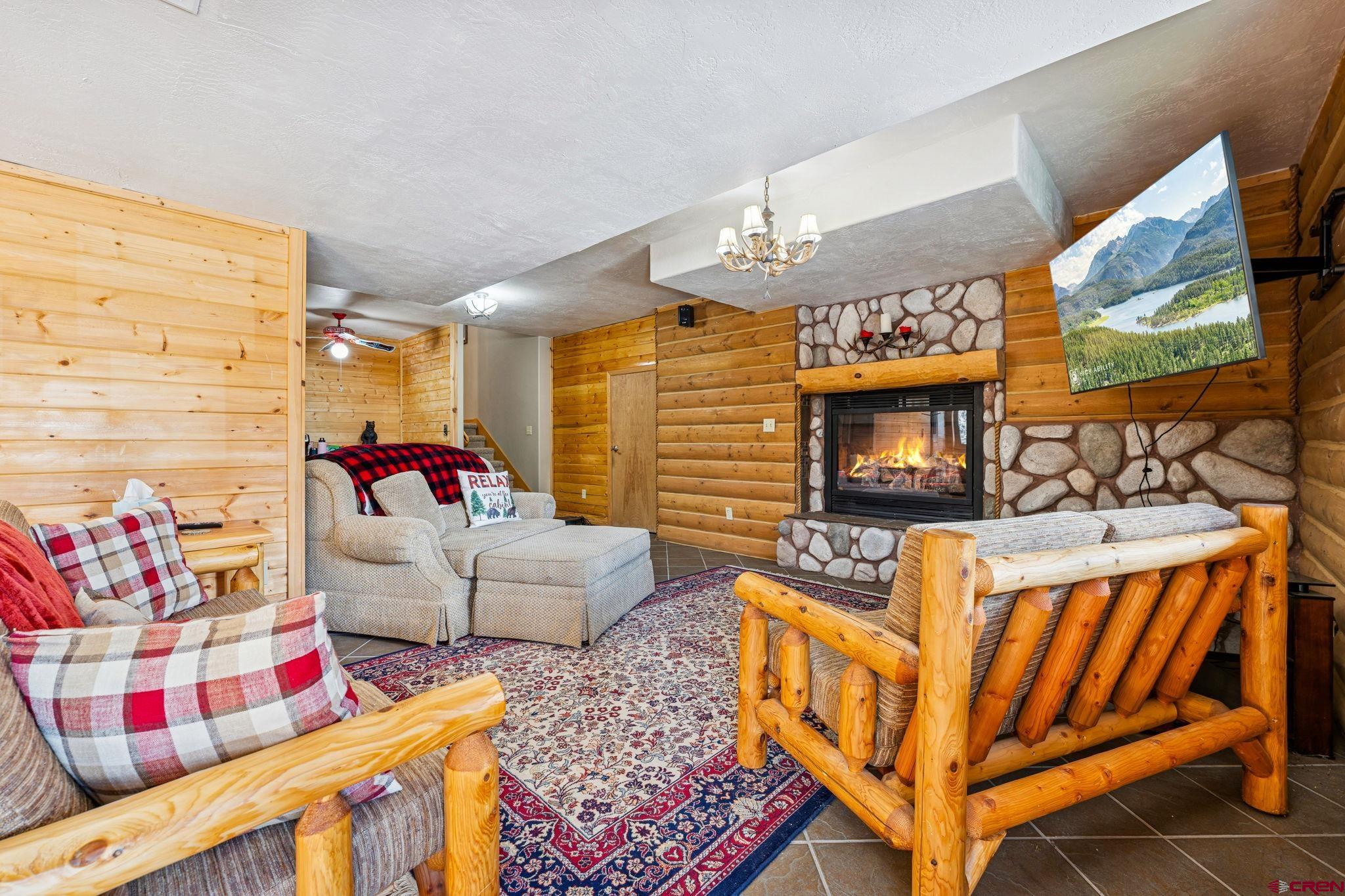 191 Aspen Drive Durango, CO 81301 - Photo 22 of 43 a living room with furniture a flat screen tv and a table