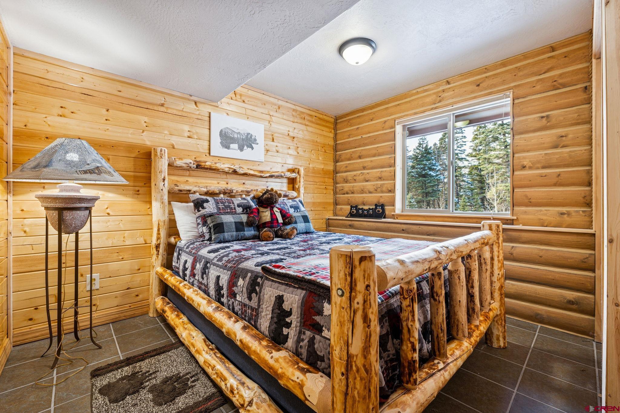 191 Aspen Drive Durango, CO 81301 - Photo 23 of 43 a bed sitting in a bedroom next to a window