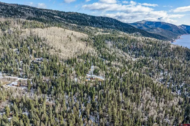 a view of a patio with furniture and a fire pit
