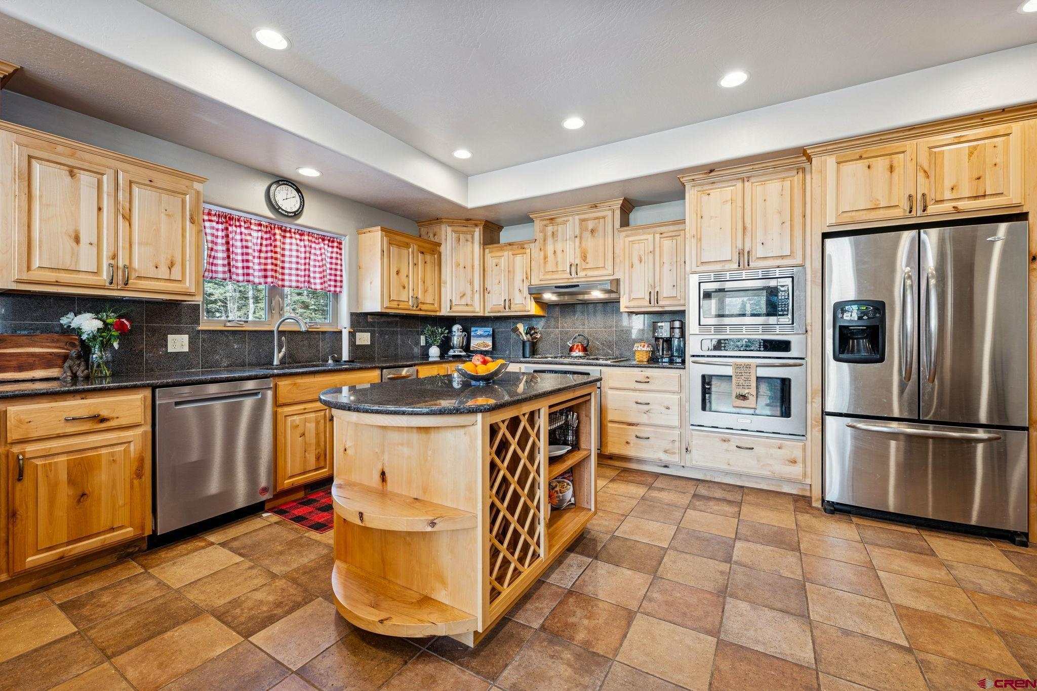 191 Aspen Drive Durango, CO 81301 - Photo 4 of 43 a kitchen with stainless steel appliances granite countertop a stove a sink and a refrigerator