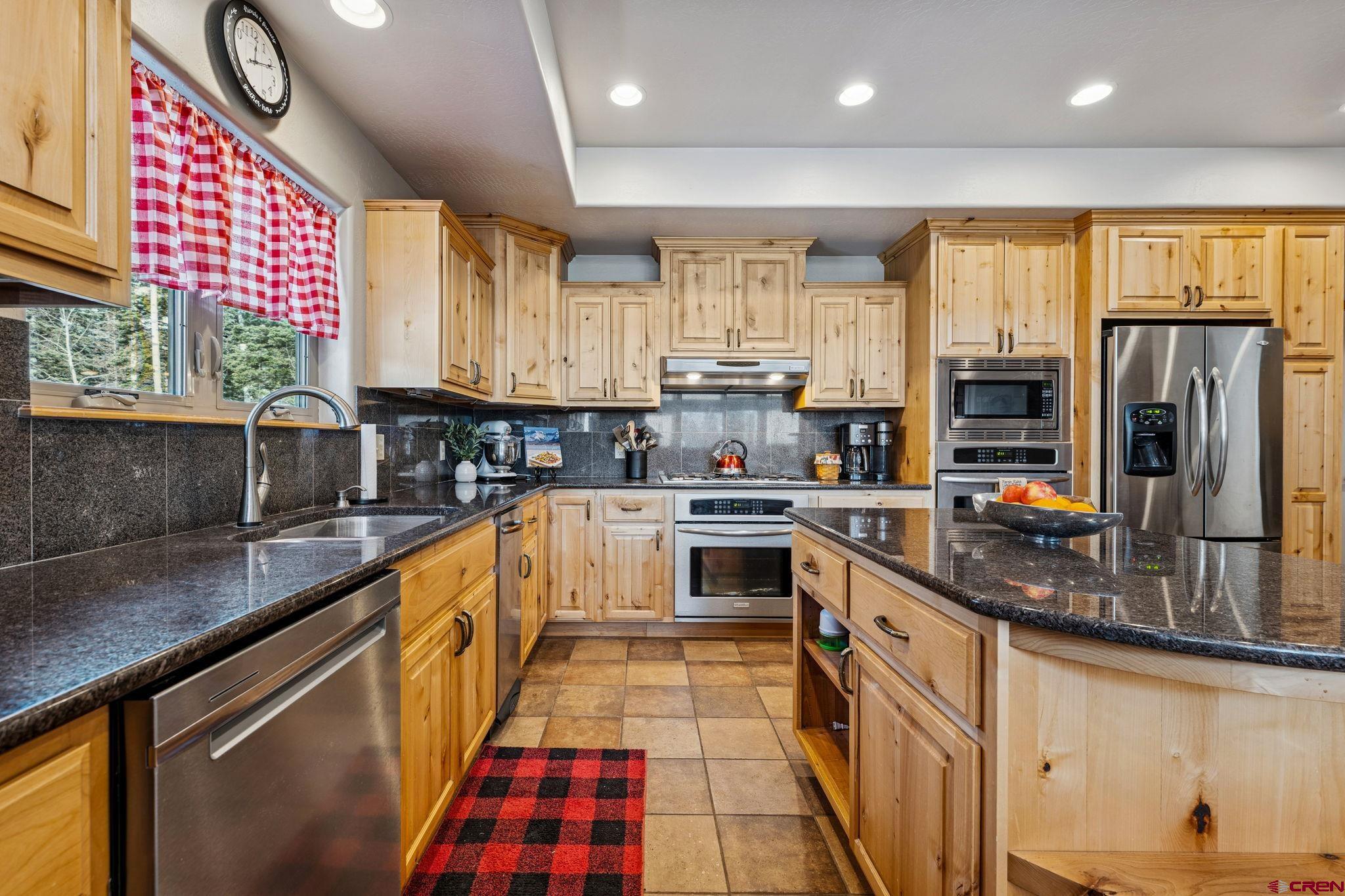 191 Aspen Drive Durango, CO 81301 - Photo 5 of 43 a kitchen with stainless steel appliances granite countertop a stove a sink and a microwave