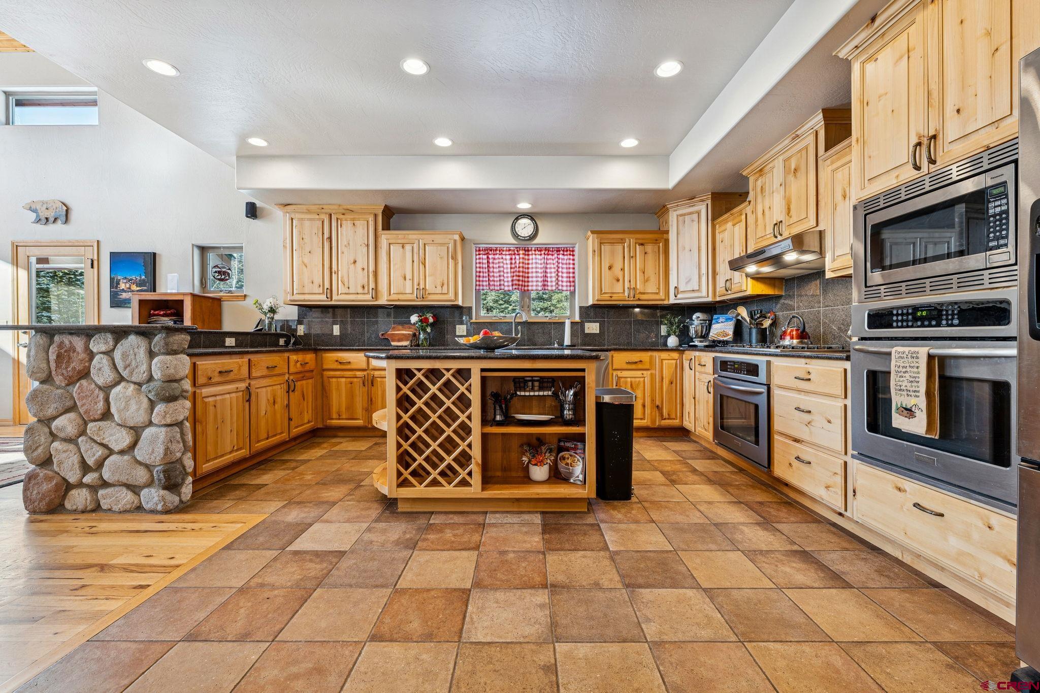 191 Aspen Drive Durango, CO 81301 - Photo 6 of 43 a kitchen with stainless steel appliances granite countertop a stove sink and cabinets