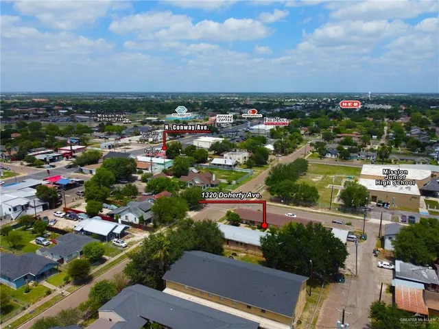 an aerial view of residential building and car parked