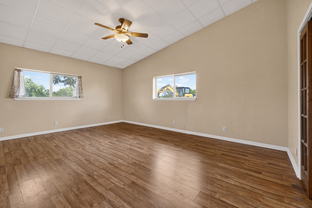 8804 Williamson Road Buda, TX 78610 - Photo 18 of 37 Vaulted ceilings and rich wood-toned flooring highlight this versatile interior space.