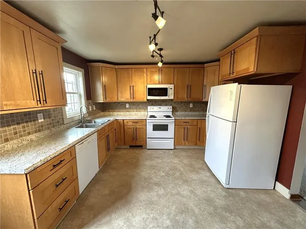 a kitchen with a stove sink and microwave