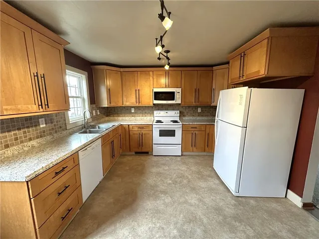 a kitchen with a stove sink and microwave