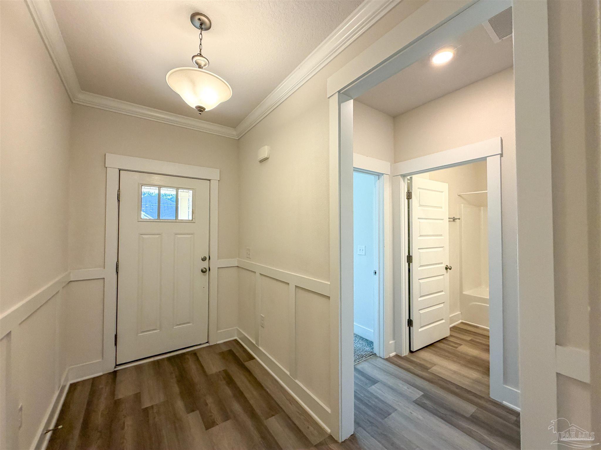 7429 Jamesville Road Pensacola, FL 32526 - Photo 17 of 24 a view of a hallway with wooden floor and staircase
