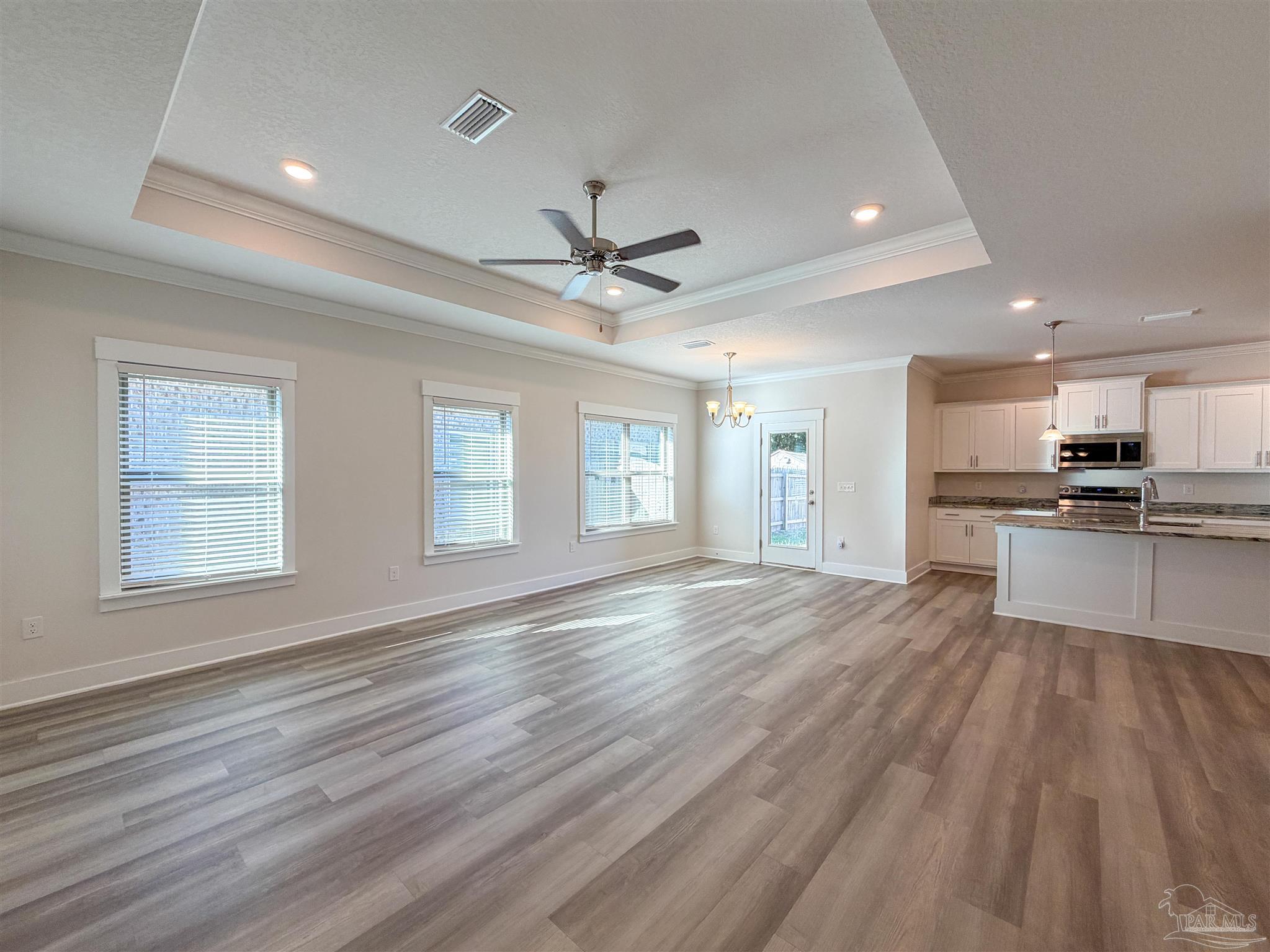 7429 Jamesville Road Pensacola, FL 32526 - Photo 2 of 24 a view of an empty room with window and wooden floor