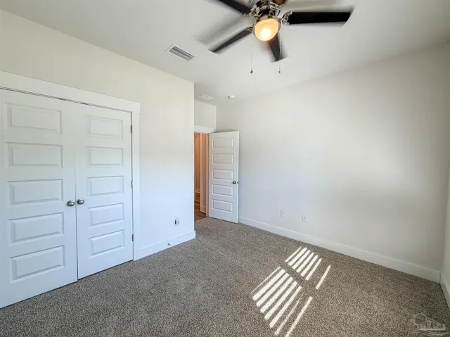 an empty room with a ceiling fan
