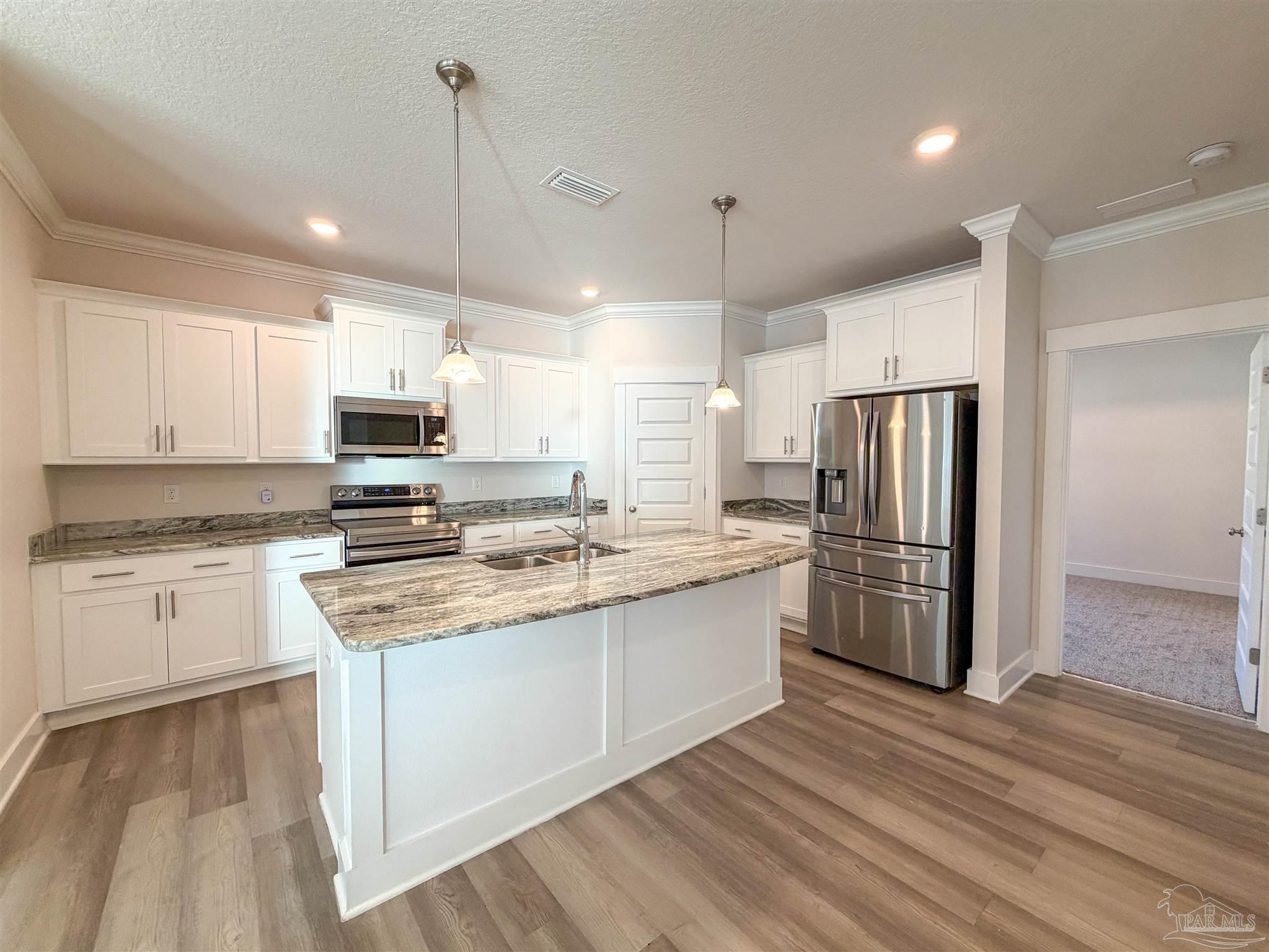 7429 Jamesville Road Pensacola, FL 32526 - Photo 3 of 24 a kitchen with stainless steel appliances a refrigerator sink and microwave