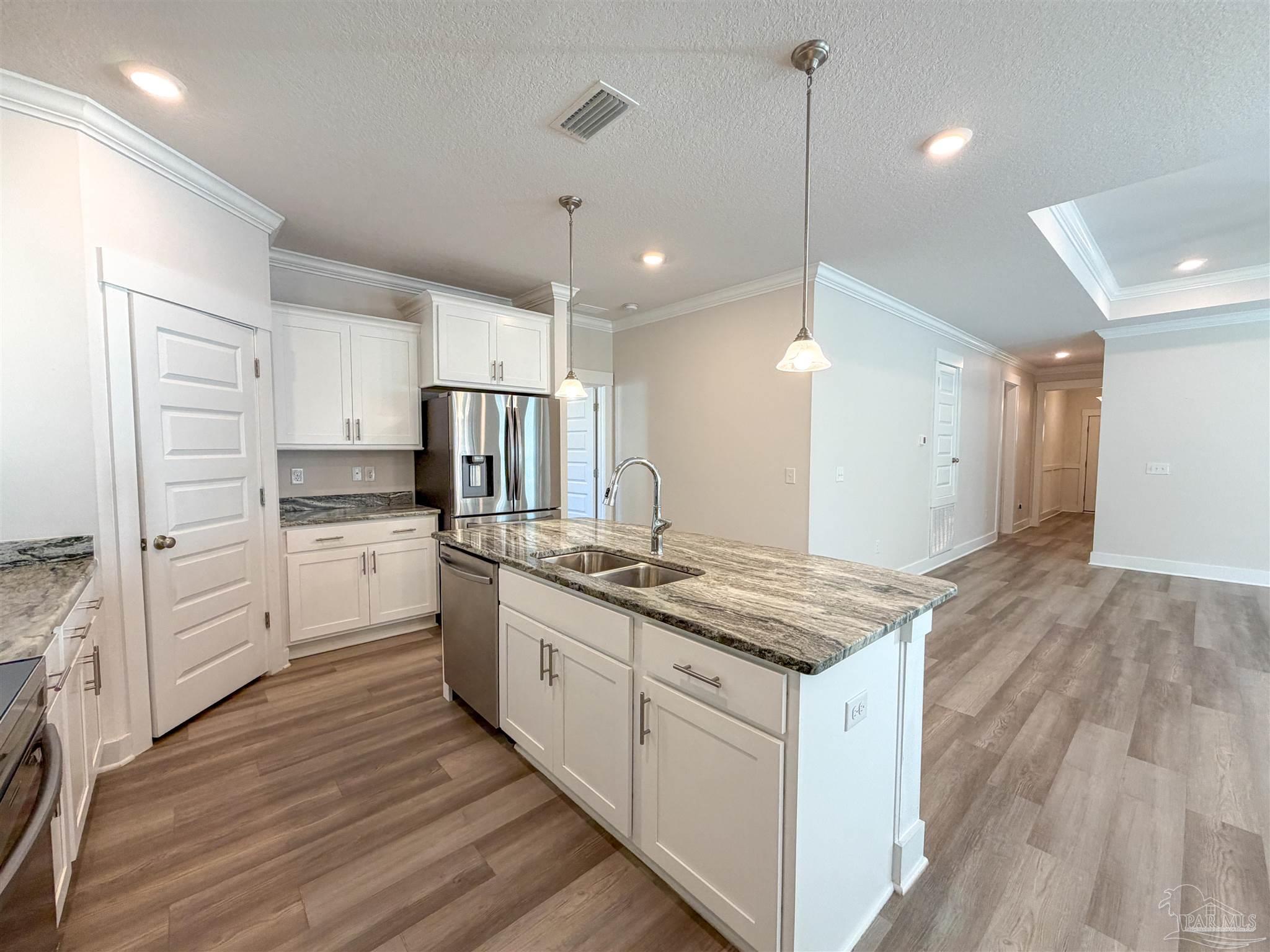 7429 Jamesville Road Pensacola, FL 32526 - Photo 5 of 24 a kitchen with white cabinets and sink