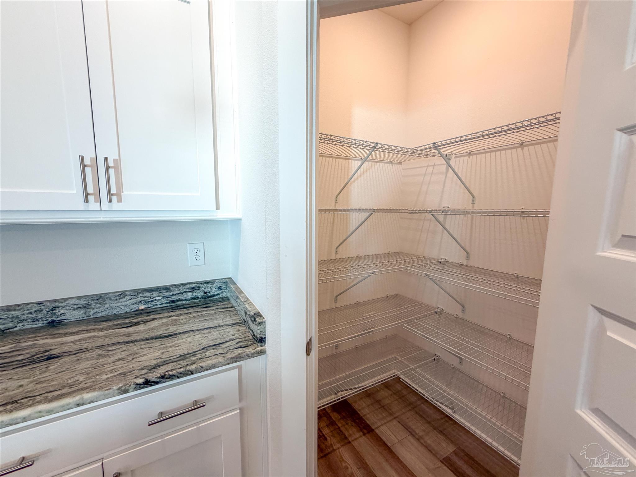 7429 Jamesville Road Pensacola, FL 32526 - Photo 6 of 24 a bathroom with a granite countertop sink and white cabinets