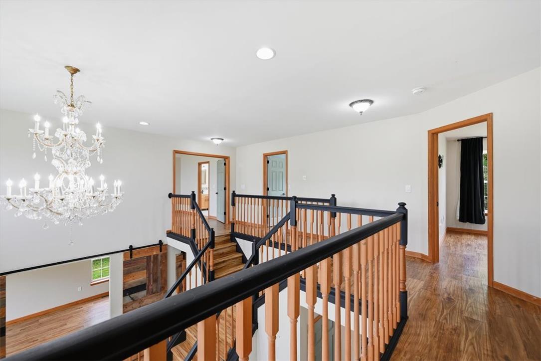 387 Blue Ridge Road Saylorsburg, PA 18353 - Photo 38 of 90 A grand chandelier illuminates this home's central stairwell and upper landing.