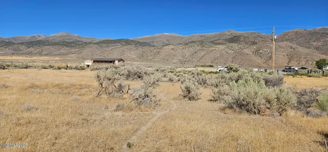 a view of mountain with sunset in background