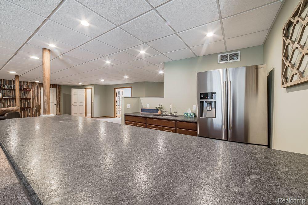 8360 Woodview Road Clarkston, MI 48348 - Photo 46 of 61 Leathered granite countertops at the wet bar