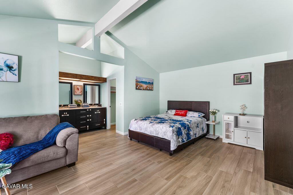 44246 Ruthron Avenue Lancaster, CA 93536 - Photo 15 of 31 a bedroom with bed and a couch