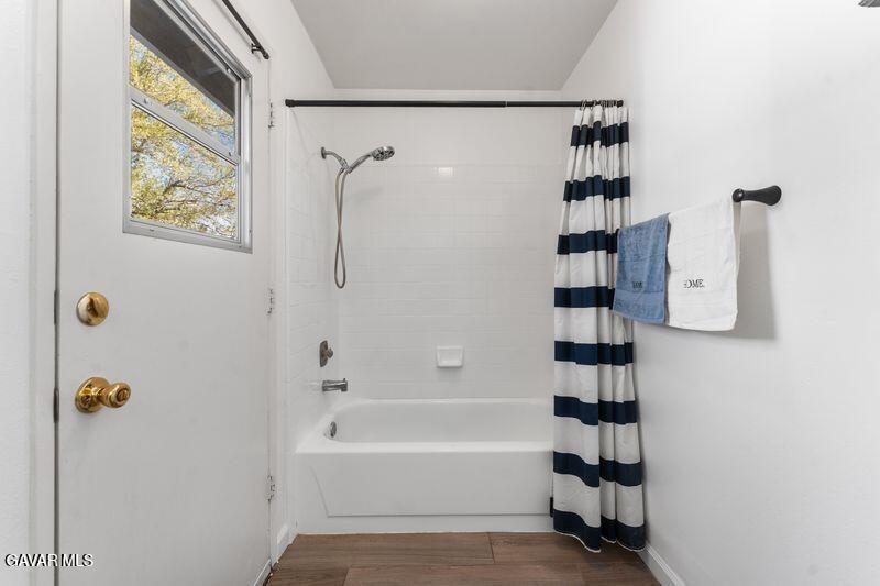 44246 Ruthron Avenue Lancaster, CA 93536 - Photo 16 of 31 a bathroom with a bathtub and a shower