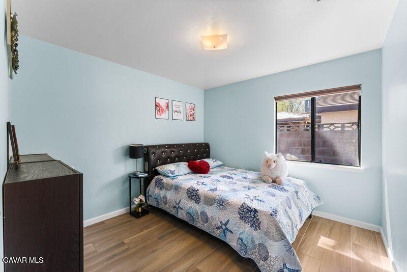 44246 Ruthron Avenue Lancaster, CA 93536 - Photo 19 of 31 a bedroom with a bed and a window