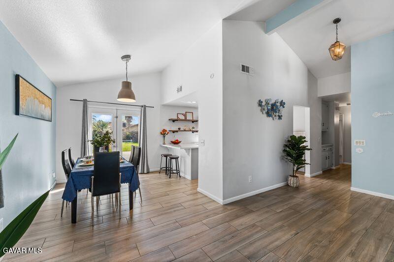 44246 Ruthron Avenue Lancaster, CA 93536 - Photo 22 of 31 a view of a dining room with furniture and wooden floor