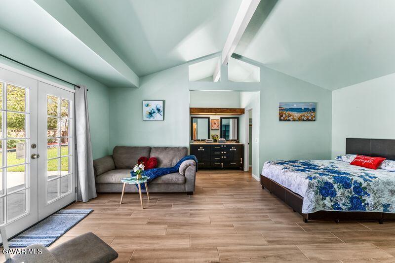 44246 Ruthron Avenue Lancaster, CA 93536 - Photo 23 of 31 a bedroom with a bed wooden floor and window