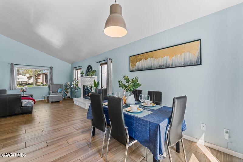 44246 Ruthron Avenue Lancaster, CA 93536 - Photo 4 of 31 a view of a dining room with furniture and wooden floor