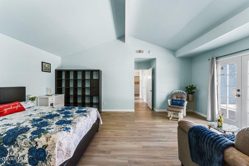 44246 Ruthron Avenue Lancaster, CA 93536 - Photo 8 of 31 a bedroom with a bed wooden floor and view