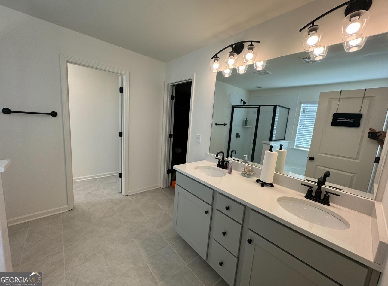 844 Venture Way Atlanta, GA 30331 - Photo 16 of 37 a bathroom with a double vanity sink a mirror and a shower