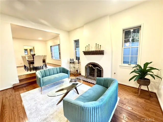 a living room with patio furniture and a flat screen tv