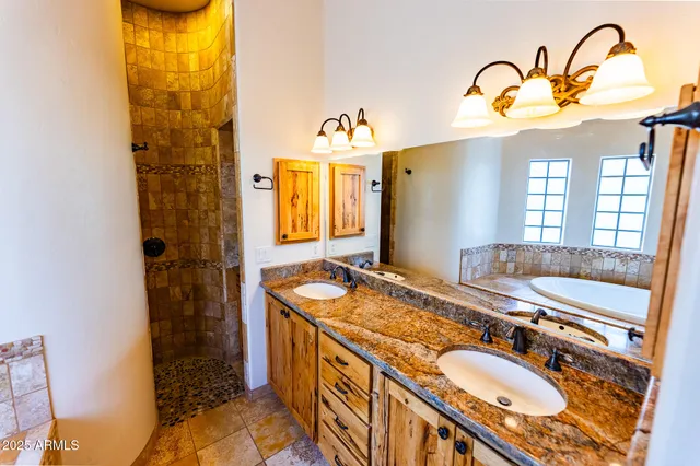 a bathroom with a tub sink and mirror