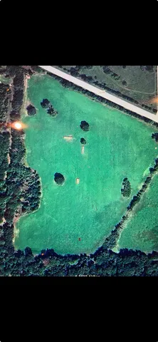 a view of a field with an outdoor space