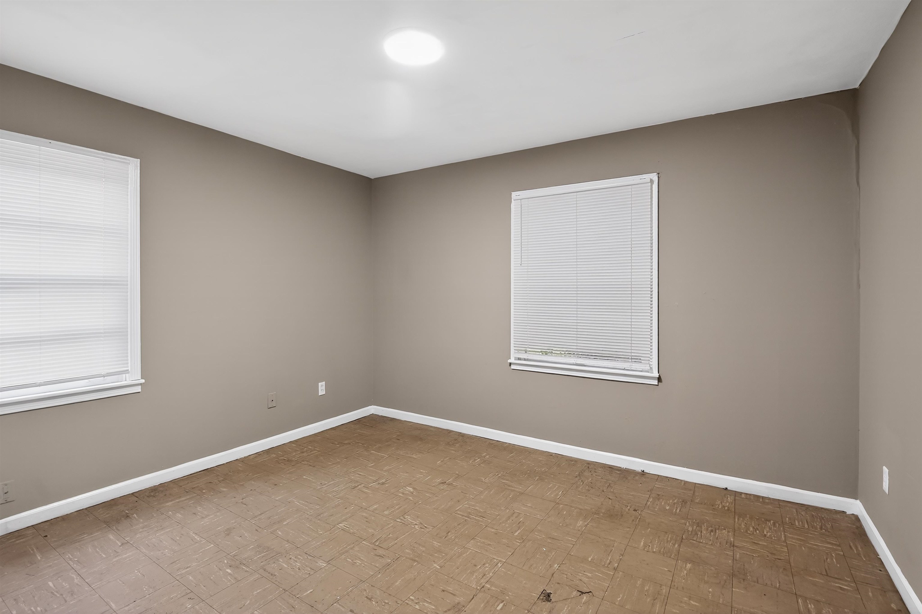 1422 Abernathy Road Memphis, TN 38116 - Photo 15 of 30 Neutral-toned room with two windows featuring white blinds, recessed ceiling lighting, and light-colored flooring