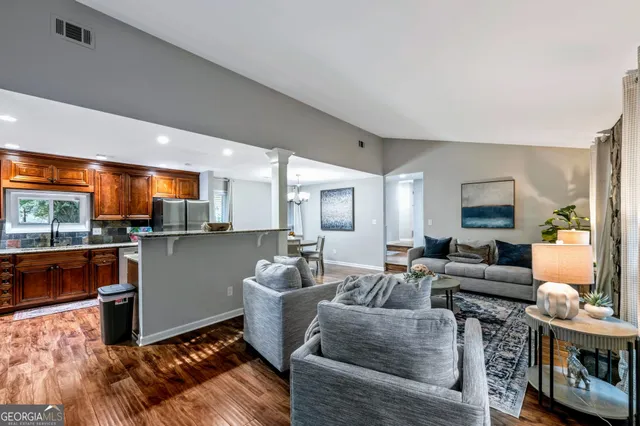 a living room with furniture and a wooden floor