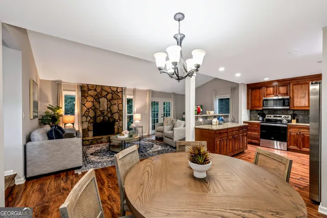 a living room with furniture kitchen and a chandelier