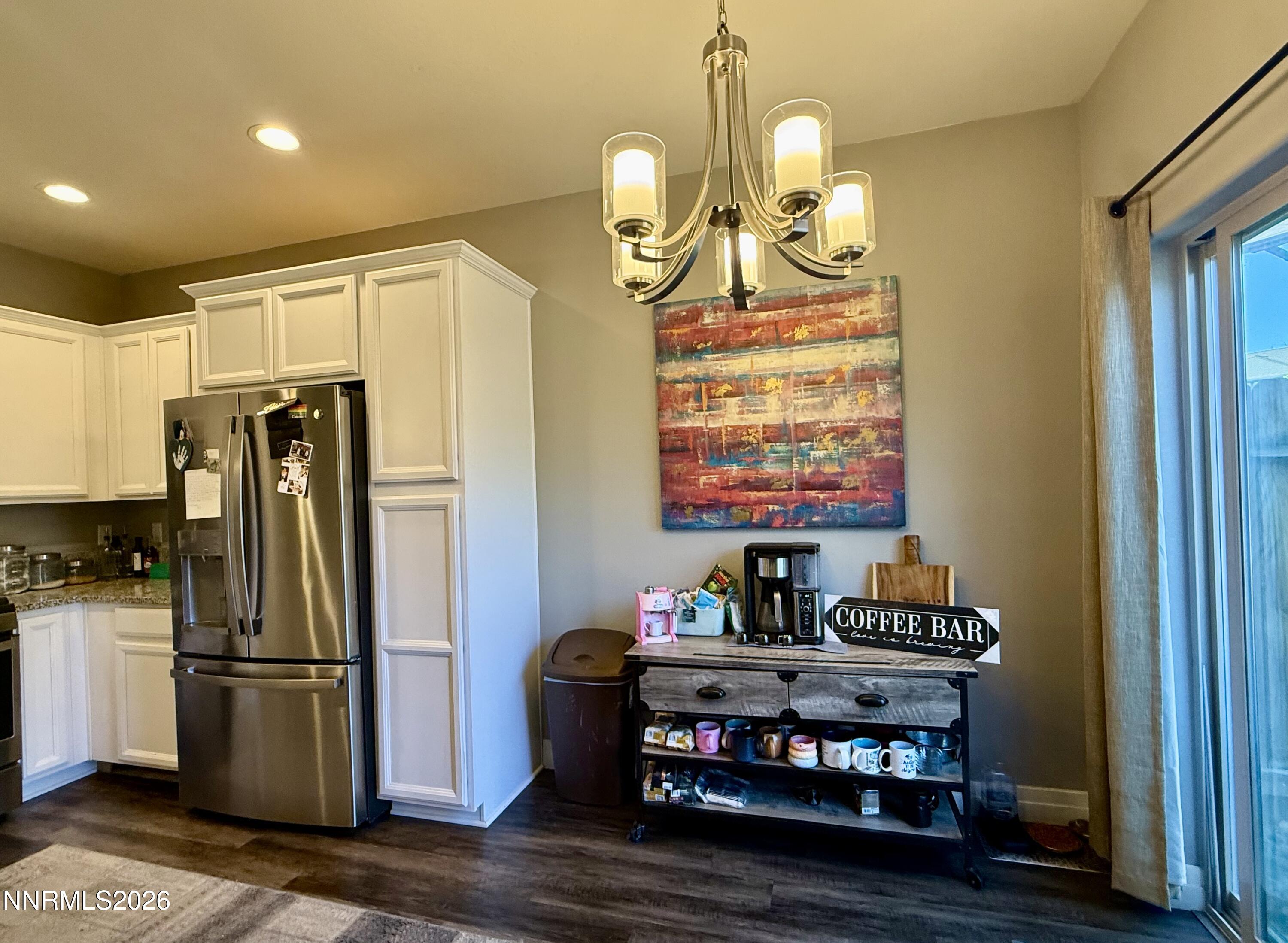 1310 Handelin Road Carson City, NV 89706 - Photo 12 of 40 a kitchen with stainless steel appliances granite countertop a refrigerator a stove a sink and a dining table with wooden floor