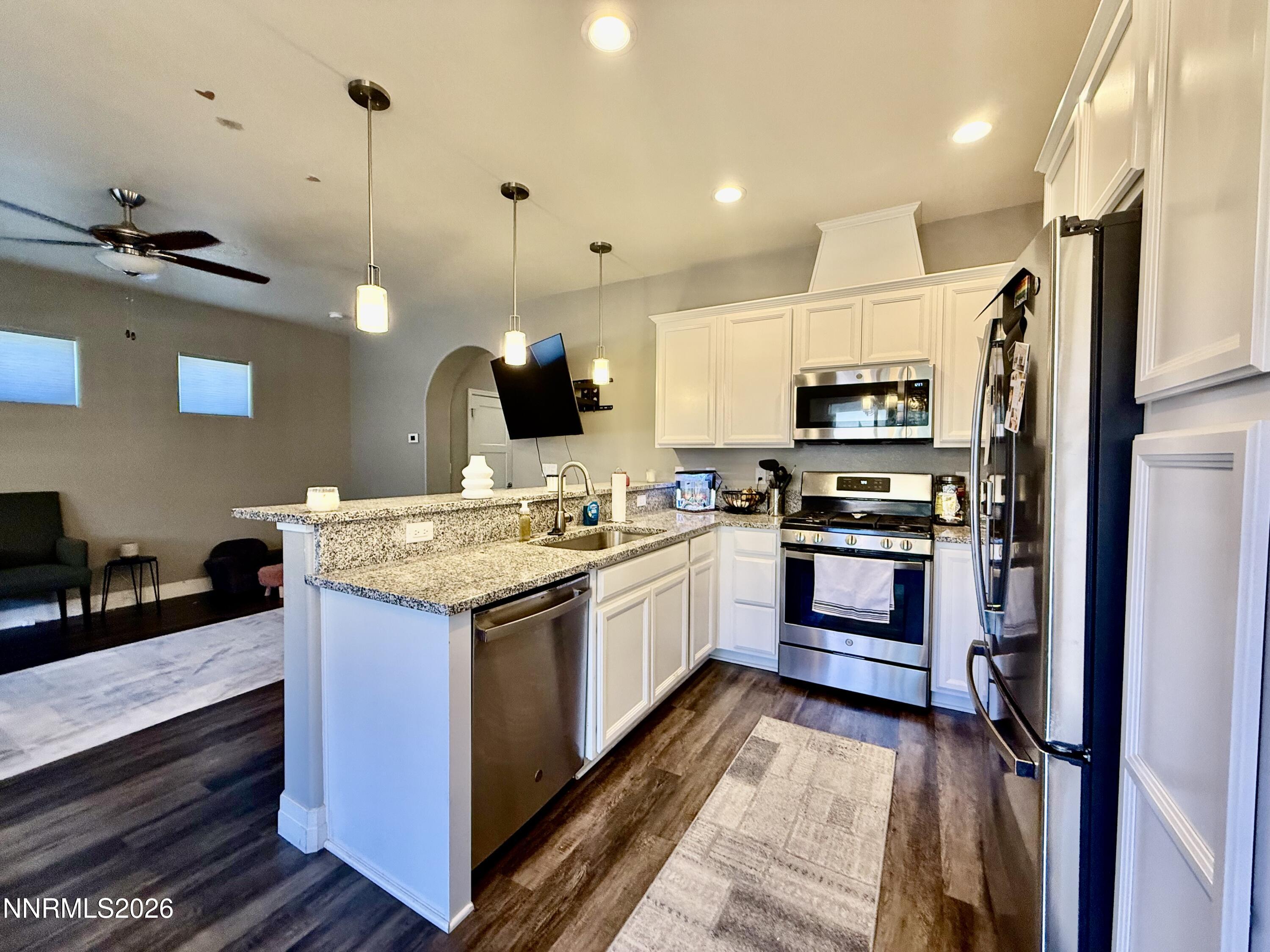 1310 Handelin Road Carson City, NV 89706 - Photo 13 of 40 a kitchen with a sink stove and microwave