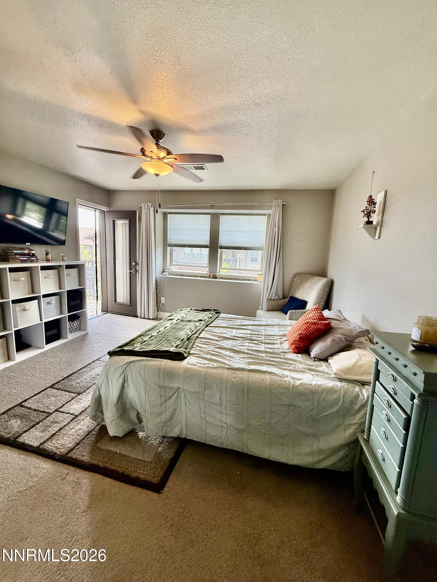 1310 Handelin Road Carson City, NV 89706 - Photo 21 of 40 a bedroom with a bed a dresser and book shelf