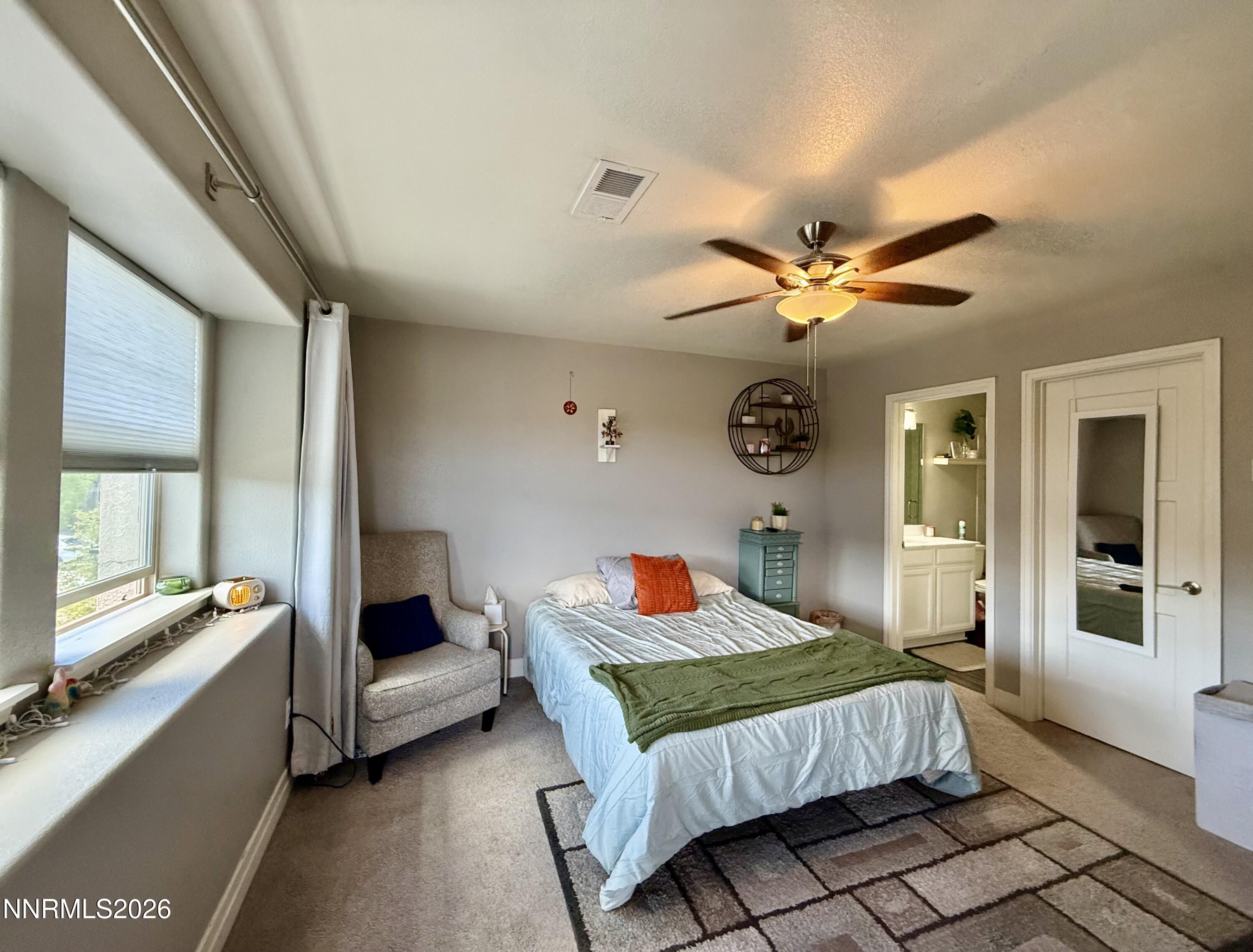 1310 Handelin Road Carson City, NV 89706 - Photo 24 of 40 a bedroom with a bed and a chandelier