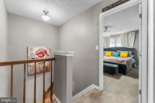 a room with white cabinets and clock on the wall