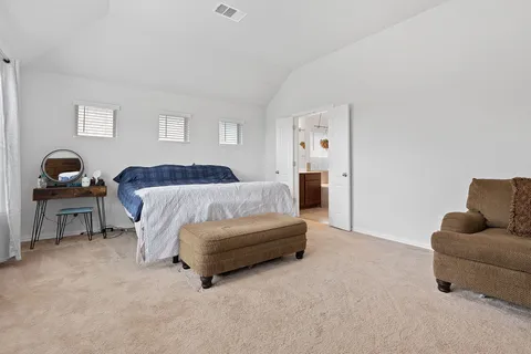 a bedroom with a bed and a couch