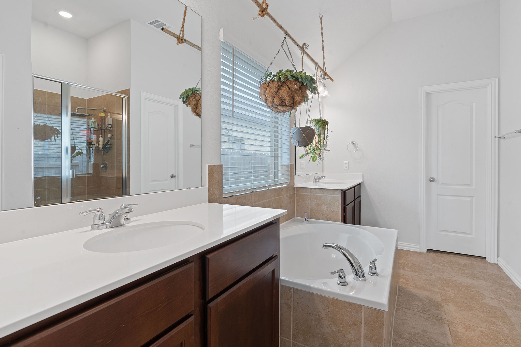 213 Treasure Trove Path Kyle, TX 78640 - Photo 21 of 29 Bathroom with two vanities, a shower stall, and a bath