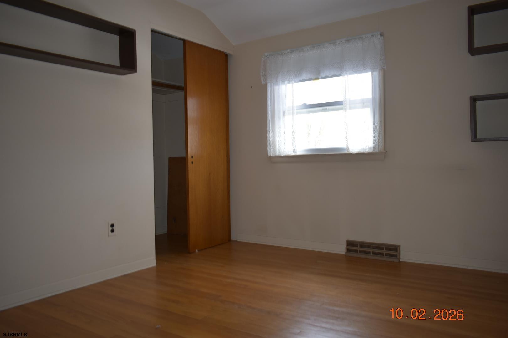 319 Barr Avenue Linwood, NJ 08221 - Photo 9 of 19 a view of an empty room with wooden floor and a window