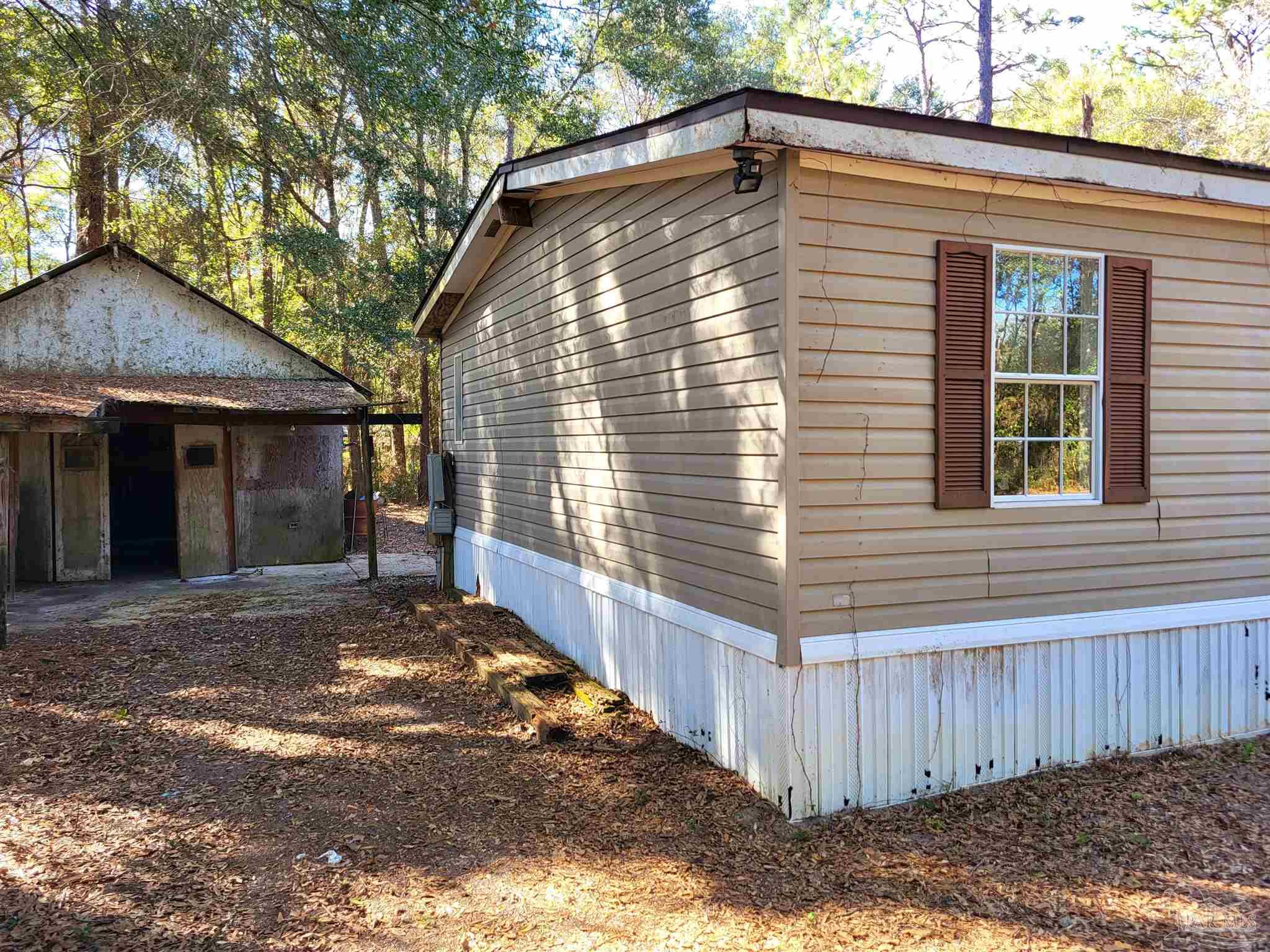 6337 Lynam Road Milton, FL 32570 - Photo 4 of 22 a view of a house with a yard and wooden fence