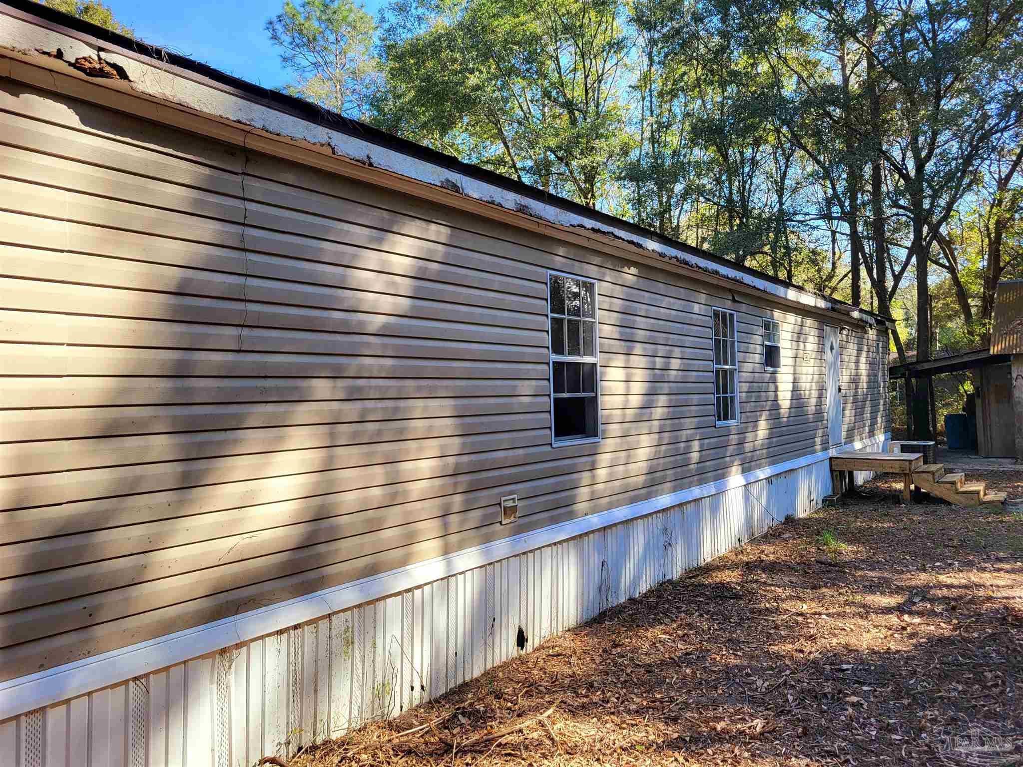 6337 Lynam Road Milton, FL 32570 - Photo 7 of 22 a view of a house with a yard