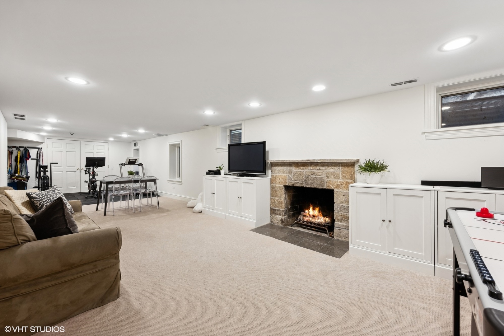 1047 Cherokee Road Wilmette, IL 60091 - Photo 26 of 36 a living room with furniture a fireplace and kitchen view