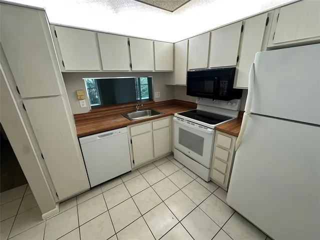 a stove top oven sitting inside of a kitchen