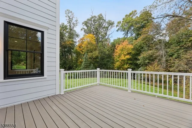 a view of balcony with wooden floor and fence