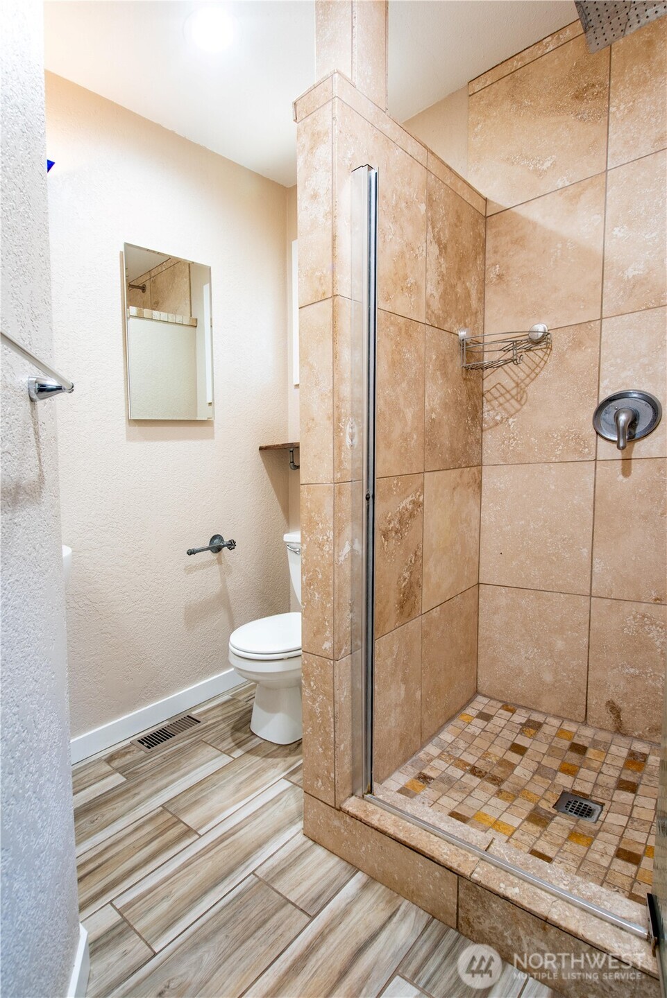 1610 16th Street Sumner, WA 98390 - Photo 12 of 28 a bathroom with a toilet and a shower