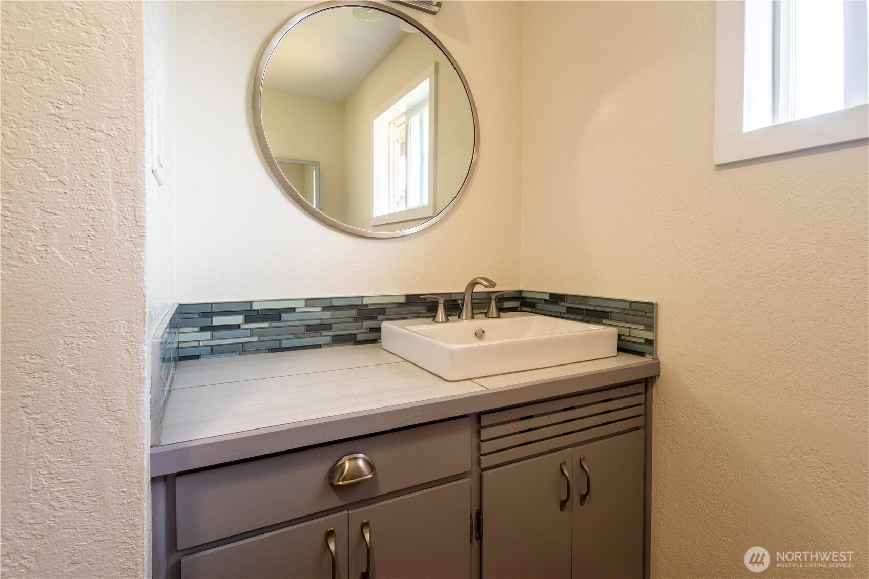 1610 16th Street Sumner, WA 98390 - Photo 17 of 28 a bathroom with a sink and a mirror