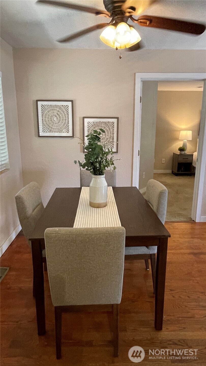 1610 16th Street Sumner, WA 98390 - Photo 7 of 28 a view of a dining room with furniture and wooden floor