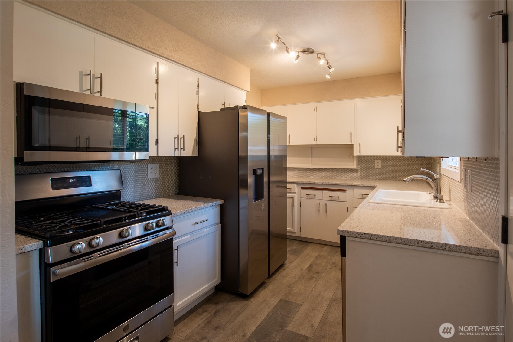 1610 16th Street Sumner, WA 98390 - Photo 8 of 28 a kitchen with a sink stove and refrigerator